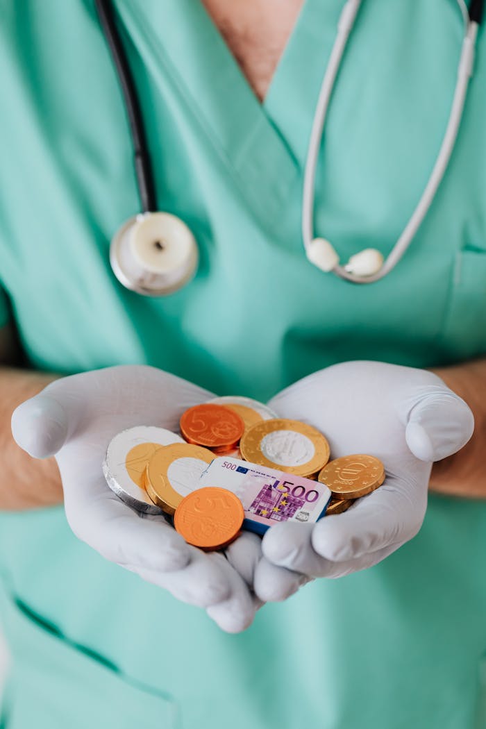 pexels-photo-4021810 From above crop faceless doctor with stethoscope on shoulders holding in hands chocolate coins